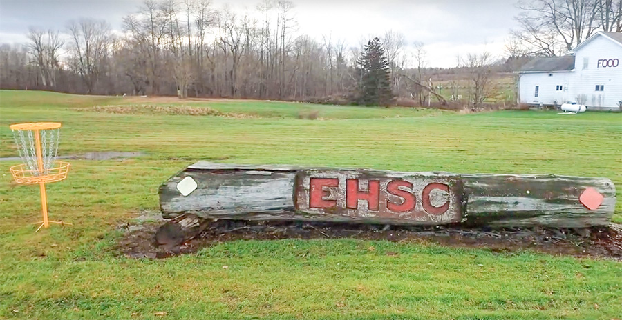 Erie Hunt and Saddle Club initials carved into log