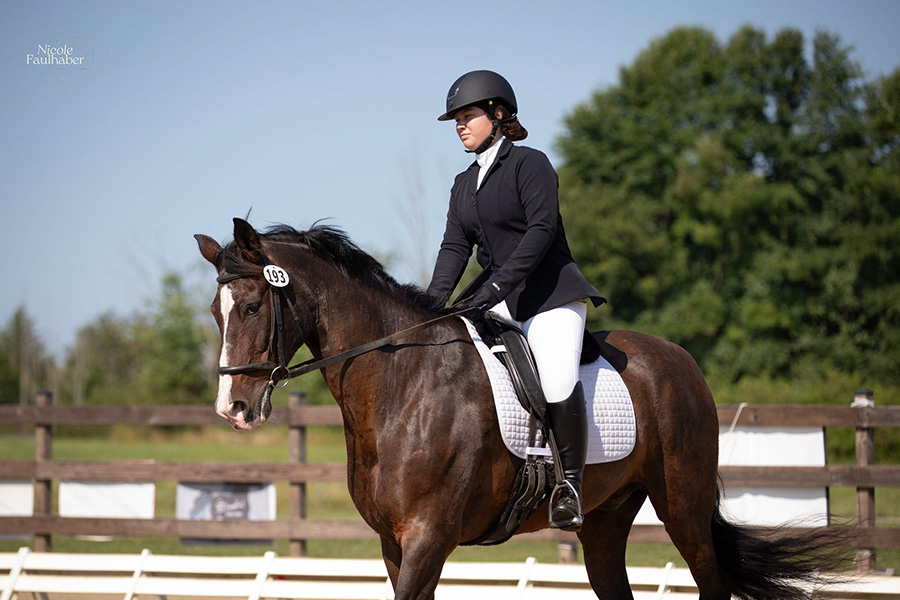 Girl riding on a dark brown and black horse